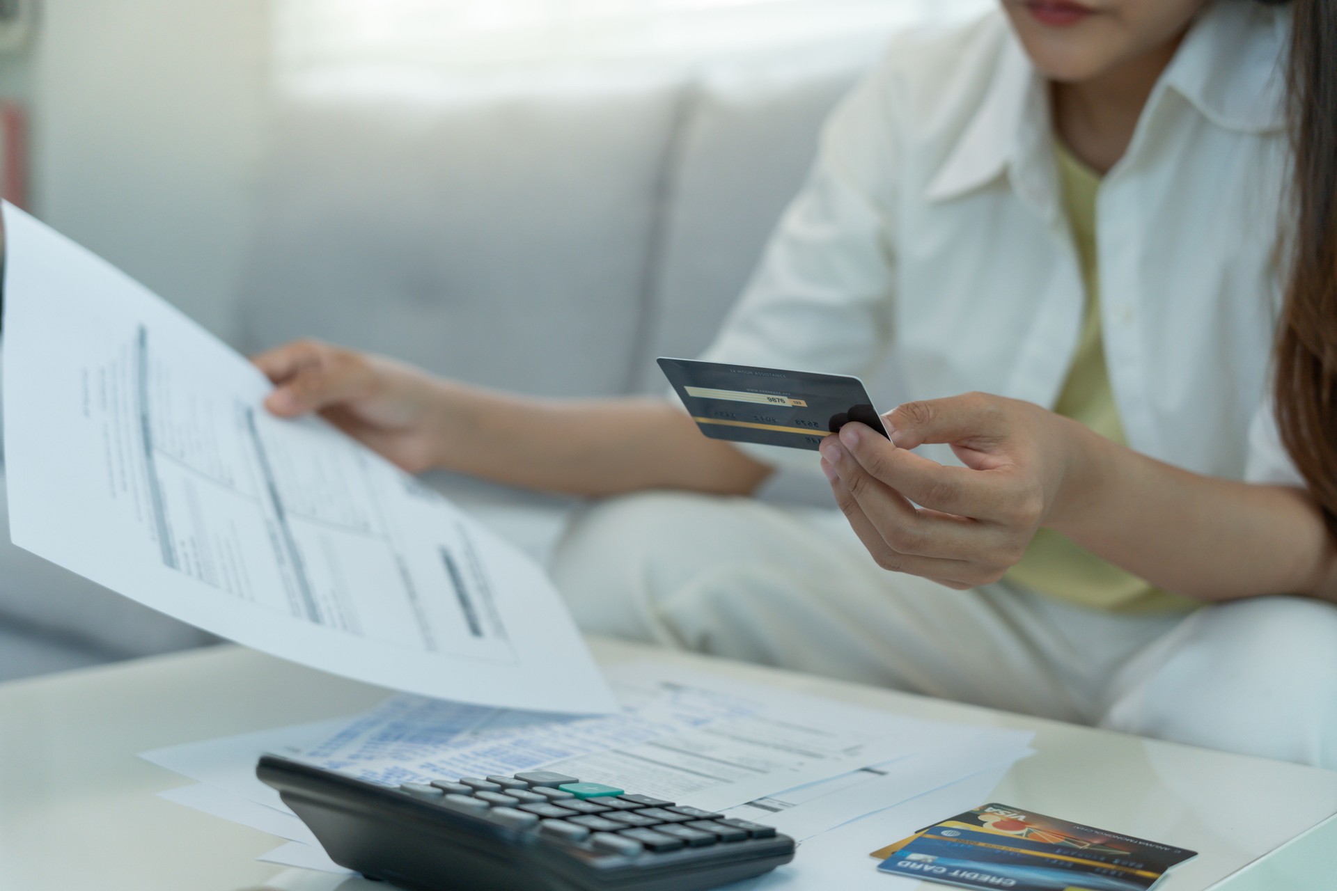 Stressed and headache woman with large bills or invoices no money to pay to expenses and credit card debt. shortage, Financial problem, bankruptcy, mortgage, loan, bankrupt, poor, empty wallet